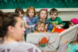 HSU Education Program student reading book to small children